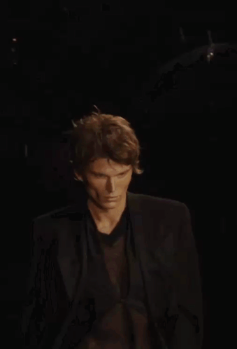 a man wearing a black jacket and a black shirt