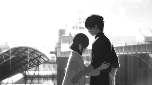 An illustrated couple hug outdoors near a station platform.