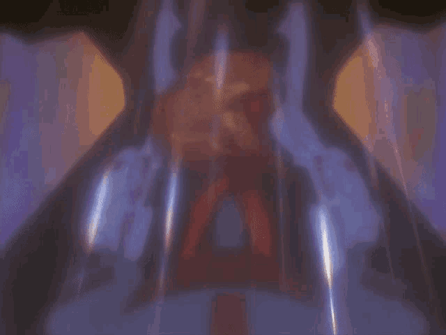 a blurred image of a person standing in a dark room with a purple background