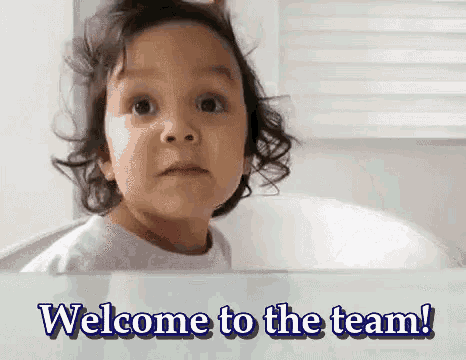 a little girl is looking out a window with the words welcome to the team behind her