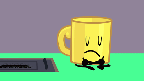 a yellow mug with an angry face is sitting on a table