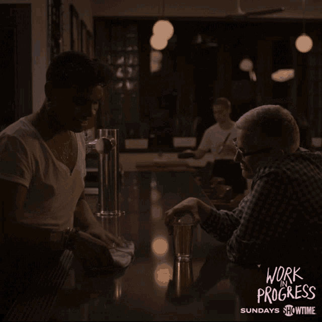 a poster for work progress shows two people talking