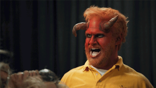 a man with horns painted on his face and a yellow shirt