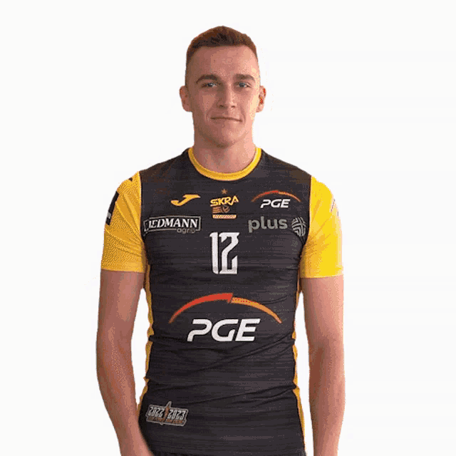 a man wearing a black and yellow shirt with pge on it