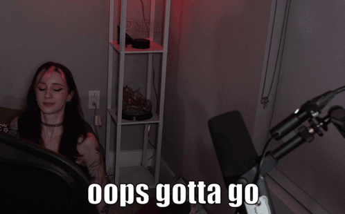 a woman sitting in front of a microphone with the words " oops gotta go "