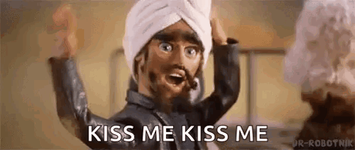 a cartoon character with a turban on his head is asking to kiss him .