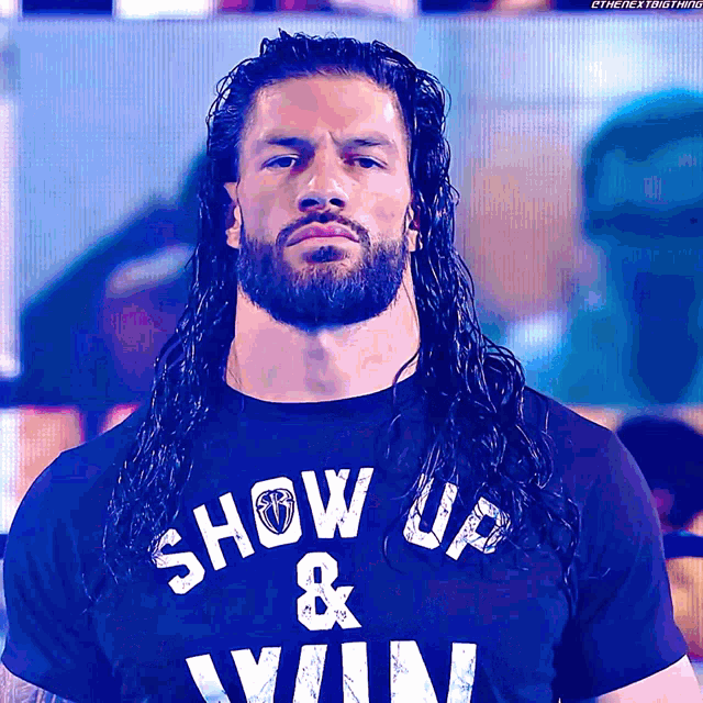 roman reigns is wearing a shirt that says show up & win