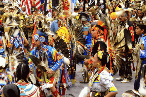 a group of people dressed in native american costumes