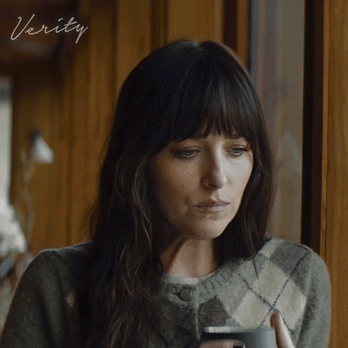 a woman looking out a window with the word verity on the bottom right