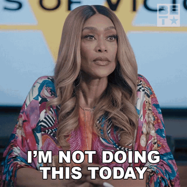 a woman says i 'm not doing this today in front of a sign