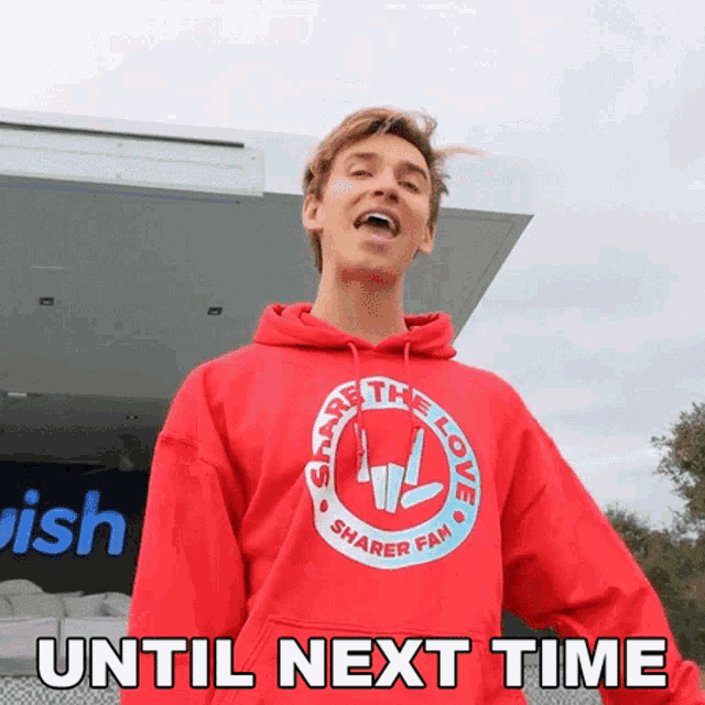 a man wearing a red share the love sharer fam hoodie
