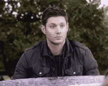 Dean Winchester from Supernatural looks forward with a subdued, uncertain expression.