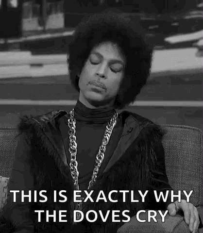 A black-and-white performer holds a microphone beneath “THIS IS EXACTLY WHY THE DOVES CRY.”