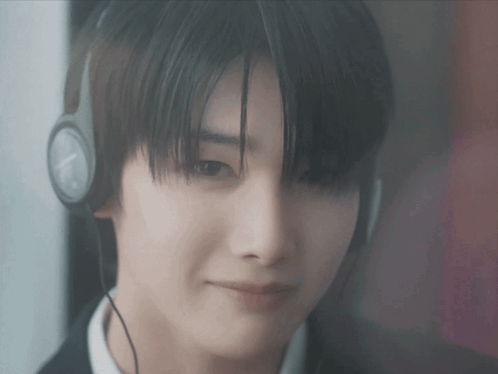 a close up of a person wearing headphones with a clock on them