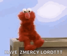 Elmo sits on a ledge beneath the caption “HAVE ZMEROYLORDTT.”