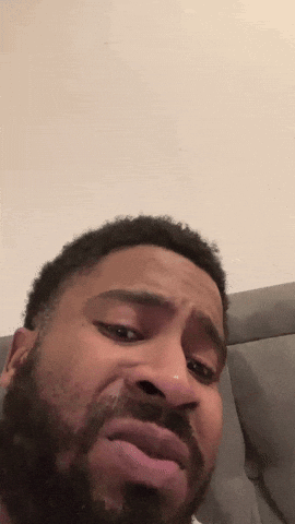 A man filmed vertically gives the camera a skeptical, disgusted side-eye.
