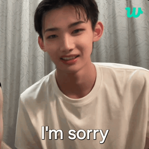 A young man faces the camera with “I’m sorry” text.