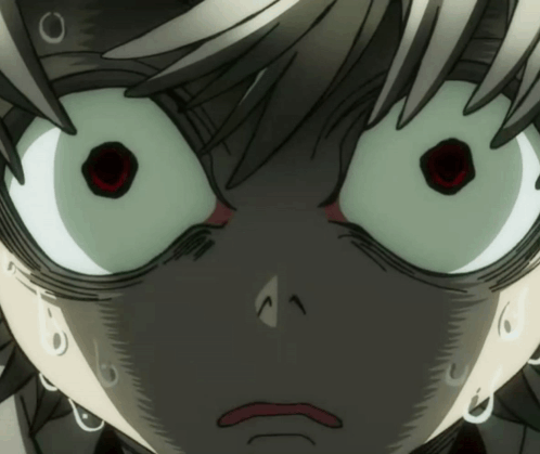 a close up of a person 's face with a surprised look on his face