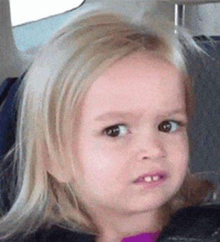 A blonde child gives an uncomfortable, doubtful side-eye.