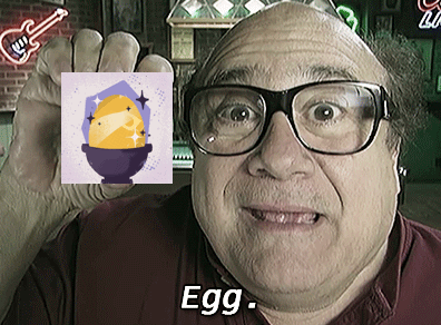 a man wearing glasses holds up a picture of an egg and the word egg in white letters