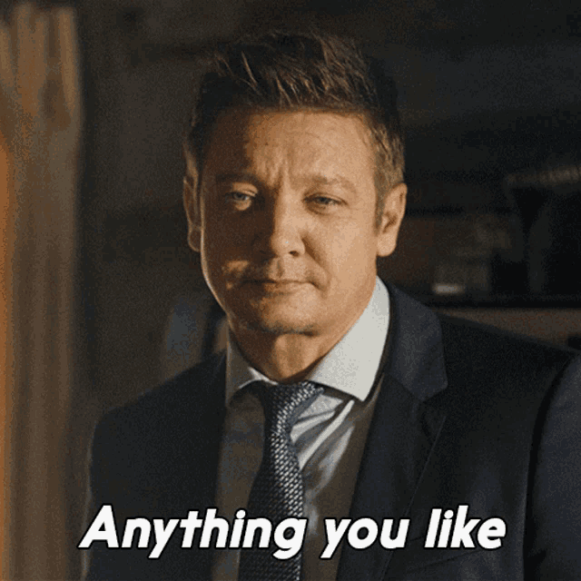 a man in a suit and tie with the words anything you like below him