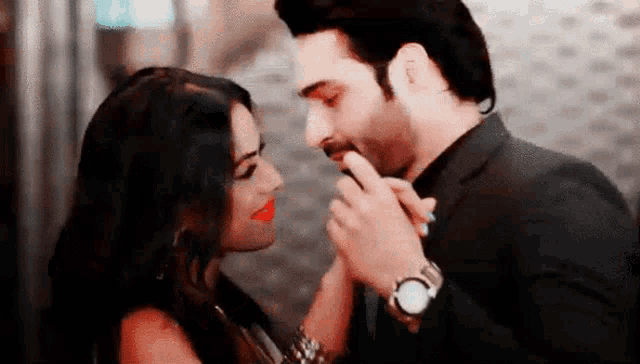 a man and a woman are kissing and holding hands .