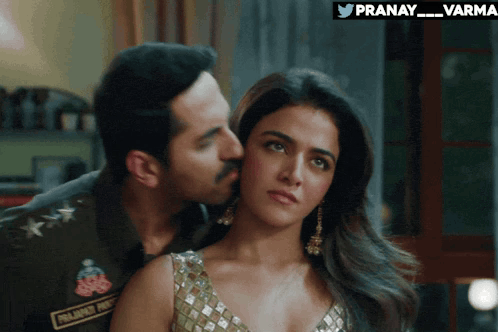 a man kisses a woman on the cheek with the hashtag pranay_varma on the bottom