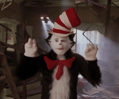 a cat in the hat costume with a red bow tie