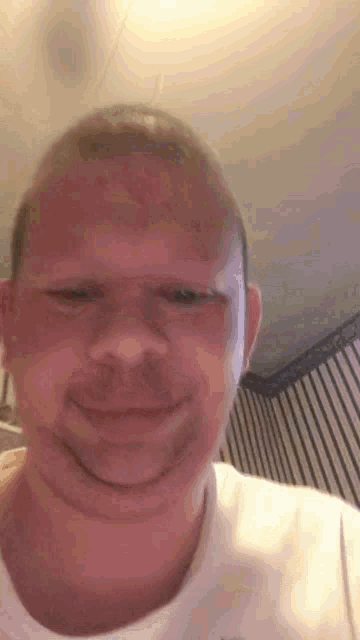 A man on a vertical selfie video gives a casual shrug.