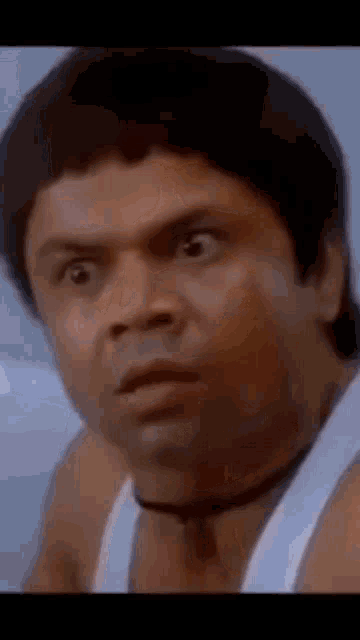 Rajpal Yadav gives a startled side-eye expression.