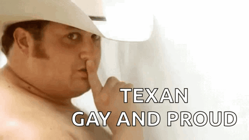 a shirtless man wearing a cowboy hat is holding his finger to his nose .