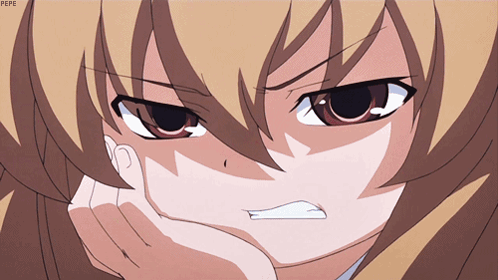 An anime girl clenches her teeth and glares in rage.
