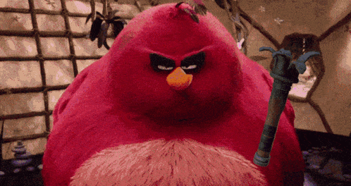 a red angry bird holding a sword in its hand