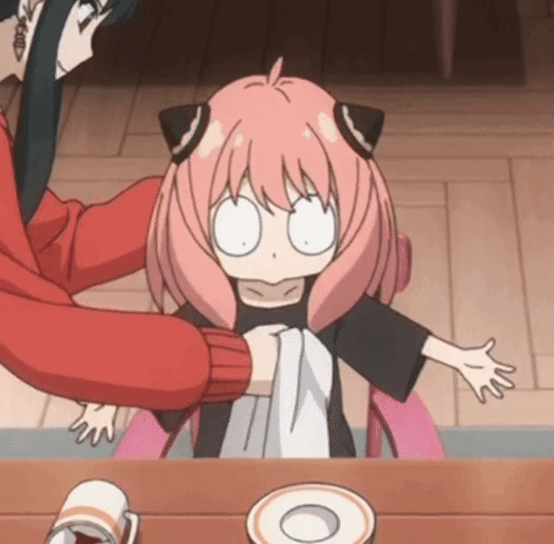 a little girl with pink hair is being held by a woman