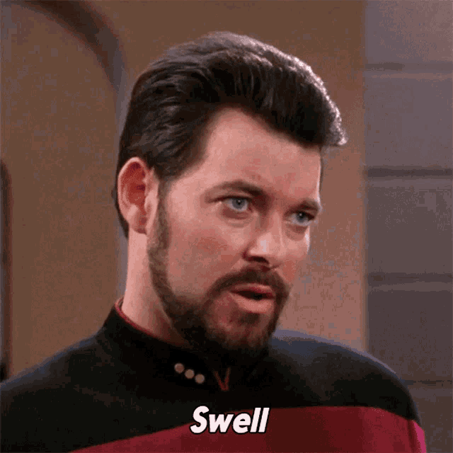 a man with a beard says the word swell in front of him