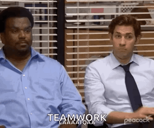 Two office coworkers stare forward beneath “TEAMWORK.”