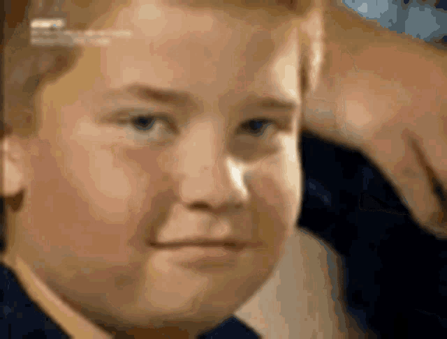 A child gives a small wink in close-up.