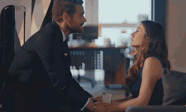a man and woman are looking at each other