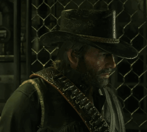 a man with a beard is wearing a black hat