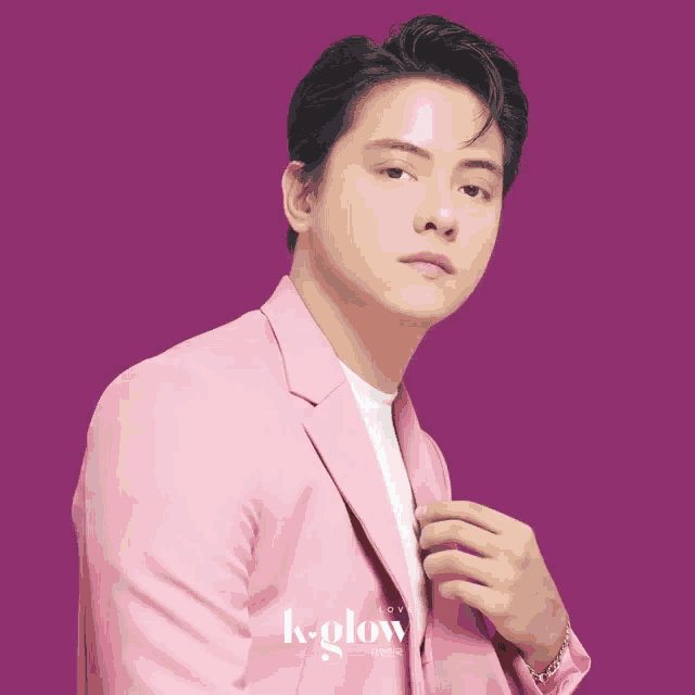 a man wearing a pink jacket and a white t-shirt with k-pop written on it