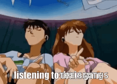 a man and a woman are sitting next to each other listening to a song .