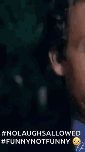 a man in a suit and tie is clapping his hands in a video .