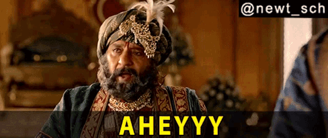a man wearing a turban and a feathered headpiece says " aheyy "