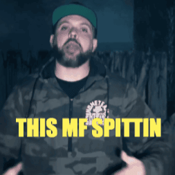 a man with a beard wearing a camo jacket says this mf spittin
