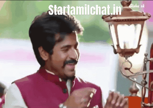a man with a mustache is smiling in front of a lamp with the words startamilchat.in written on the bottom
