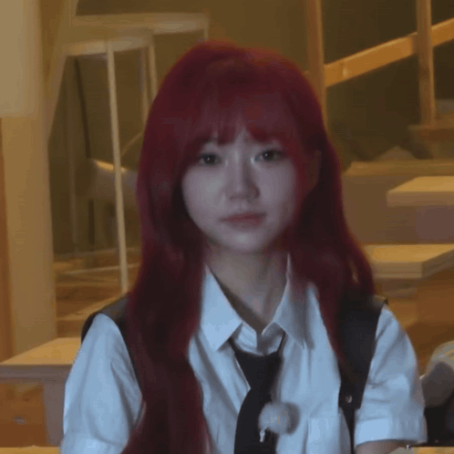 a woman with red hair is wearing a white shirt and tie