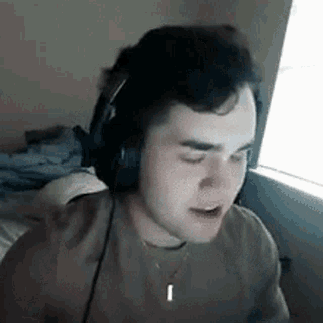 Young man covers his face with one hand in embarrassment.