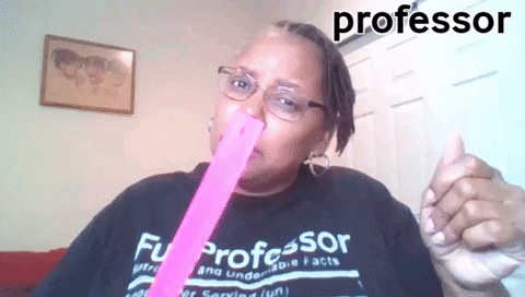 a woman in a professor shirt is holding a pink stick