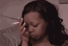 A woman rubs her forehead with her eyes down in visible stress.
