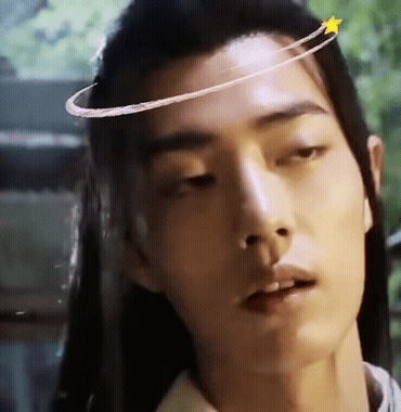a close up of a man 's face with long hair and a star on his head .